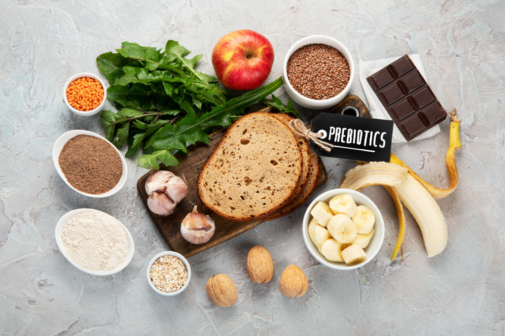 Healthy wholefood flatlay with greens, fruit, nuts and grains